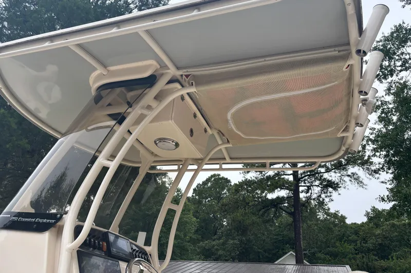 Slide: The Image of 2021 Grady-White 251 Coastal Explorer boat canopy and console, surrounded by trees. - 18