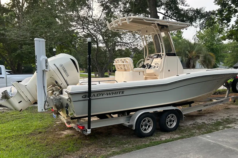 Slide: The Image of 2021 Grady-White 251 Coastal Explorer boat on trailer, parked outdoors. - 2