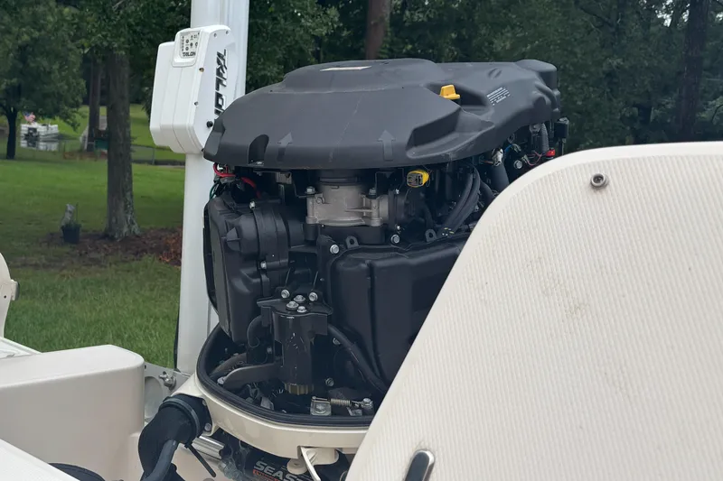 Slide: The Image of 2021 Grady-White 251 Coastal Explorer boat engine close-up, outdoors. - 21