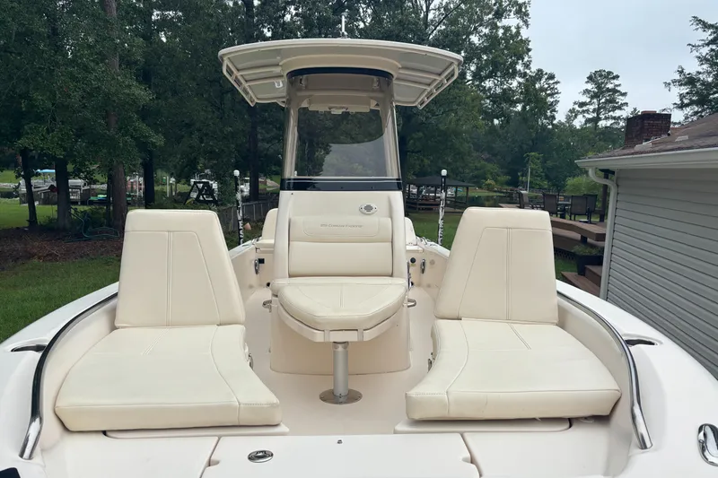 Slide: The Image of 2021 Grady-White 251 Coastal Explorer boat with white seating and canopy, surrounded by trees. - 22