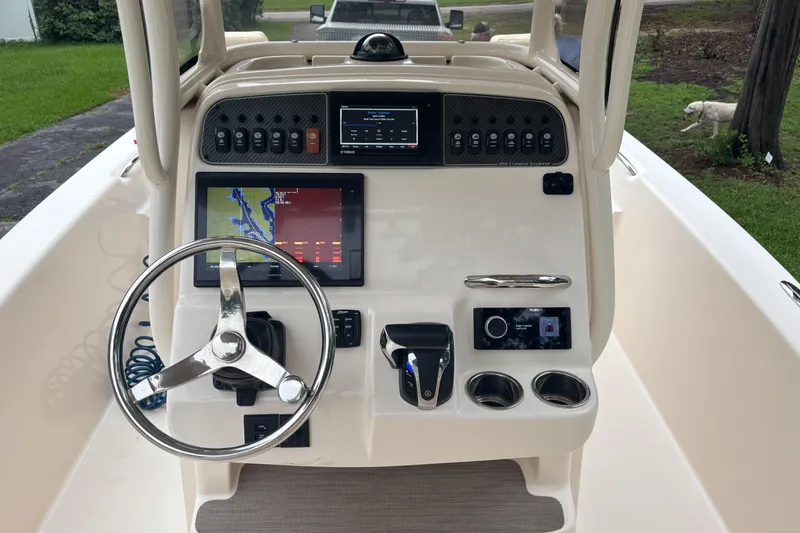 Slide: The Image of 2021 Grady-White 251 Coastal Explorer boat dashboard with navigation and control systems. - 24