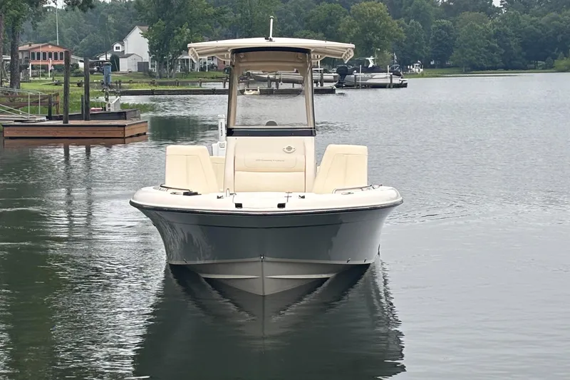 Slide: The Image of 2021 Grady-White 251 Coastal Explorer boat on a calm lake near docks and trees. - 32