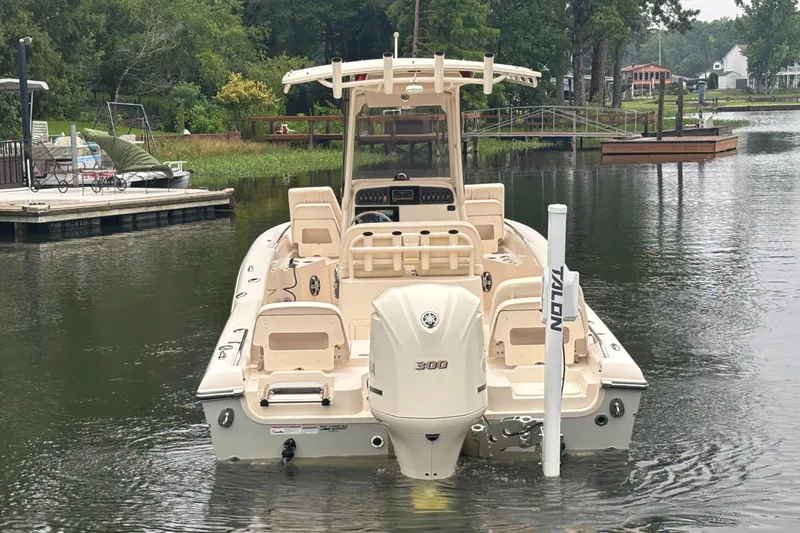 Slide: The Image of 2021 Grady-White 251 Coastal Explorer boat on a calm lake near docks. - 34