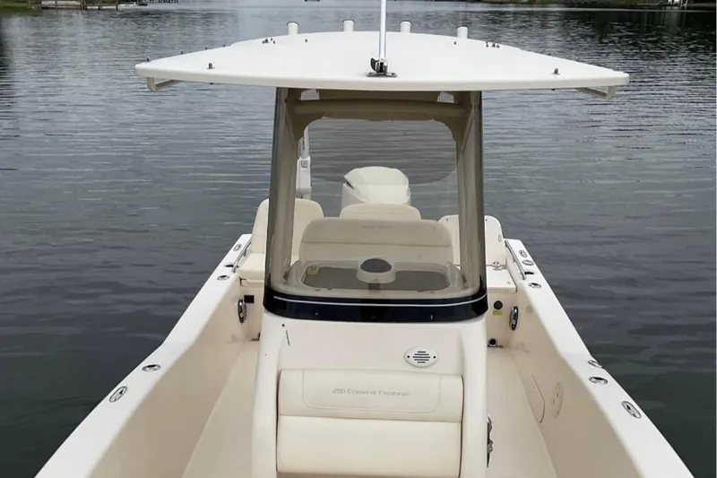 Slide: The Image of 2021 Grady-White 251 Coastal Explorer boat on calm water, showcasing helm and seating area. - 5
