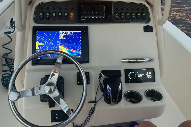 Slide: The Image of 2021 Grady-White 251 Coastal Explorer boat dashboard with navigation and control systems. - 6