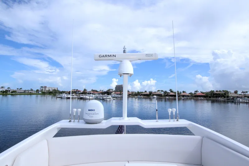 Slide: The Image of 2015 Dyna 60 yacht with Garmin radar, serene waterfront view, clear blue sky. - 11