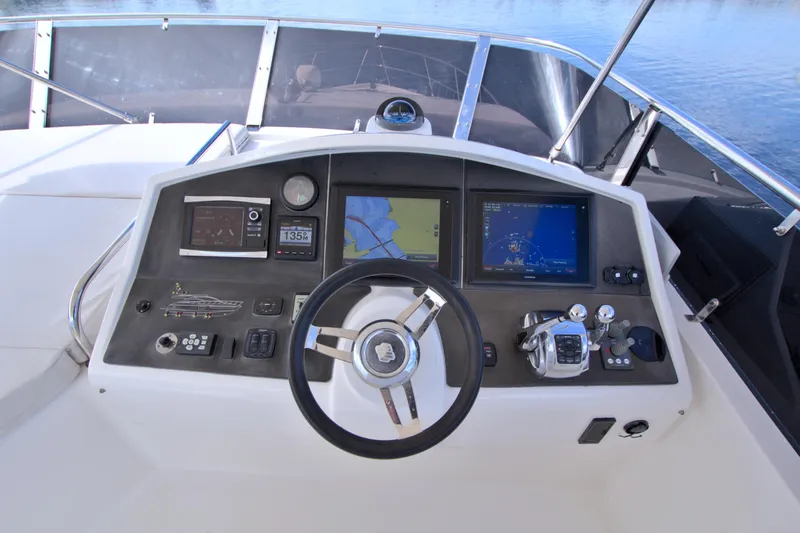 Slide: The Image of Cockpit of 2015 Dyna 60 yacht with navigation screens and steering wheel. - 17