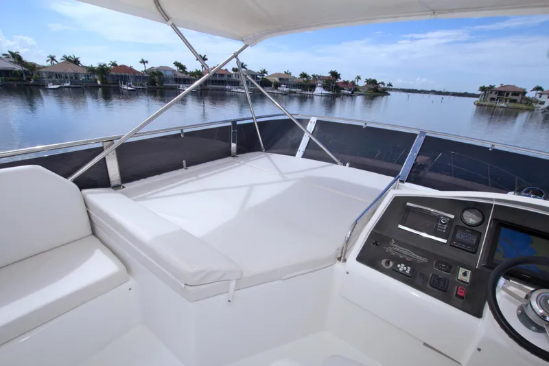Slide: The Image of Helm of 2015 Dyna 60 yacht with waterfront view and modern controls. - 18