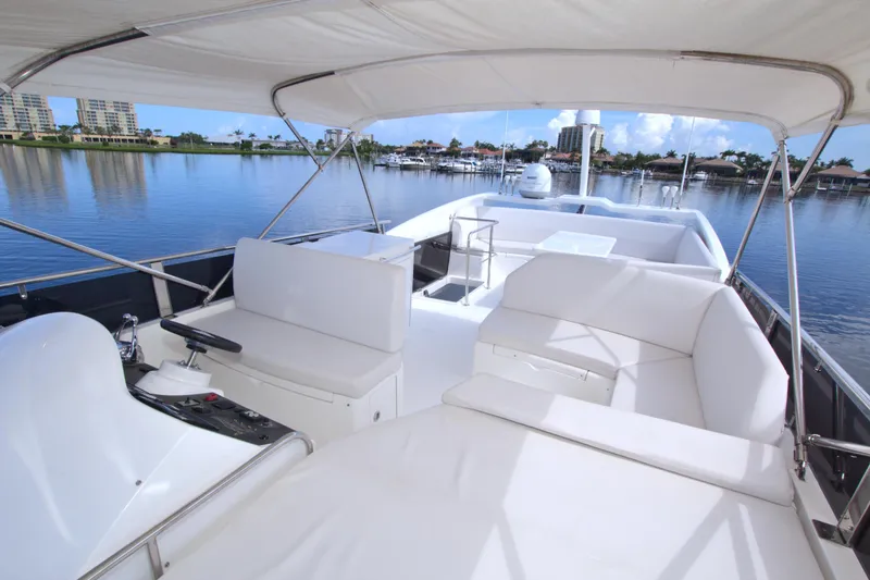 Slide: The Image of Luxurious 2015 Dyna 60 yacht interior with white seating, overlooking serene waterfront views. - 19