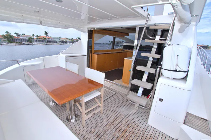 Slide: The Image of Luxury Dyna 60 yacht deck with dining area and stairs, 2015 model. - 21