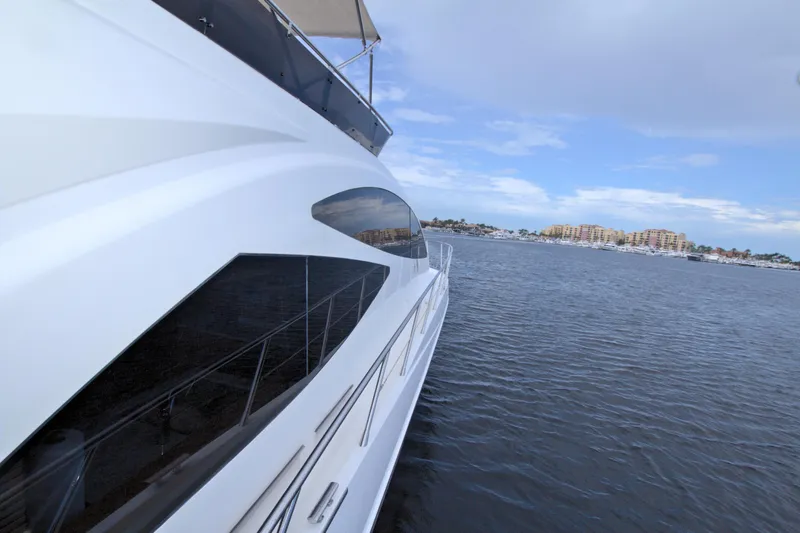 Slide: The Image of Sleek 2015 Dyna 60 yacht cruising on calm waters under a partly cloudy sky. - 22