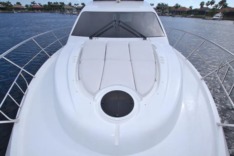 Slide: The Image of 2015 Dyna 60 yacht deck with sunbathing area, surrounded by water. - 25