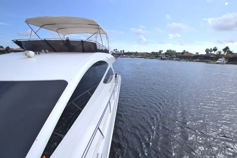 Slide: The Image of 2015 Dyna 60 yacht cruising on a sunny day in a scenic waterway. - 28