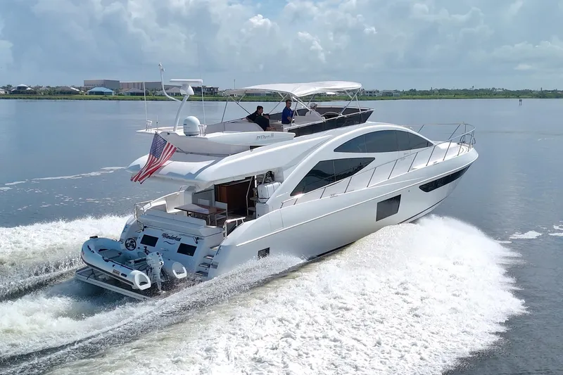 Slide: The Image of Luxurious 2015 Dyna 60 yacht cruising on calm waters under a clear sky. - 3