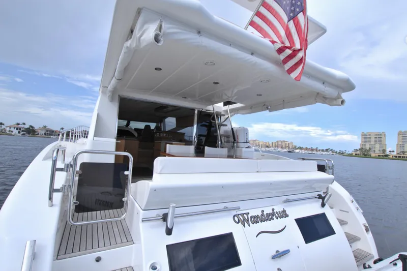 Slide: The Image of Luxury yacht Dyna 60, 2015 model, with American flag, docked near waterfront buildings. - 32