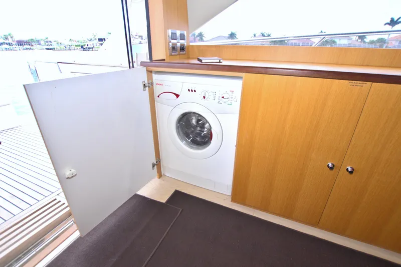Slide: The Image of Laundry area on a 2015 Dyna 60 yacht with a washing machine. - 37