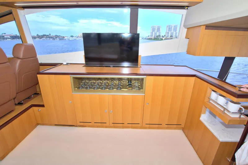 Slide: The Image of Luxurious interior of 2015 Dyna 60 yacht with TV, glass cabinet, and ocean view. - 41