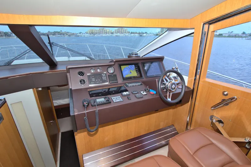 Slide: The Image of Helm of 2015 Dyna 60 yacht with navigation equipment and leather seating. - 47