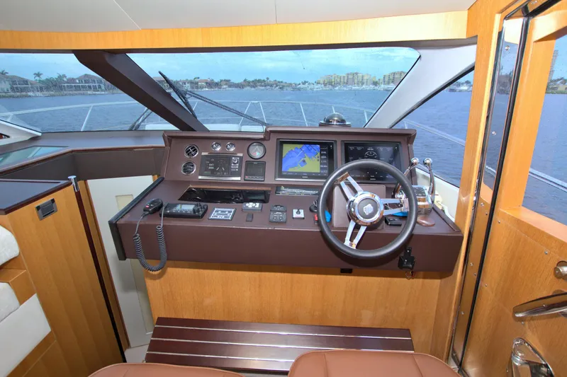Slide: The Image of Helm of 2015 Dyna 60 yacht with navigation equipment and steering wheel. - 49