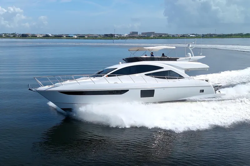 Slide: The Image of Luxurious 2015 Dyna 60 yacht cruising on calm waters under a clear sky. - 6