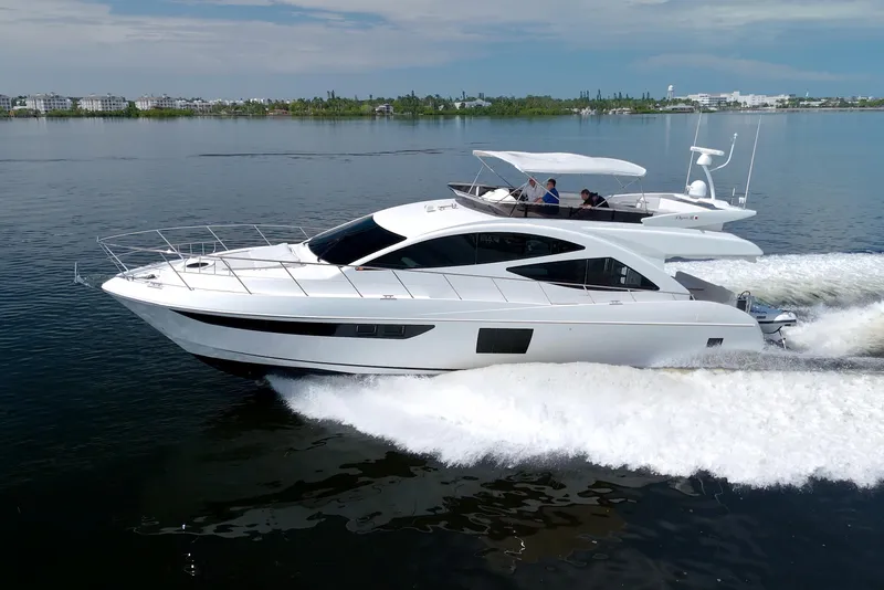 Slide: The Image of Luxury 2015 Dyna 60 yacht cruising on calm waters, showcasing sleek design and elegance. - 7