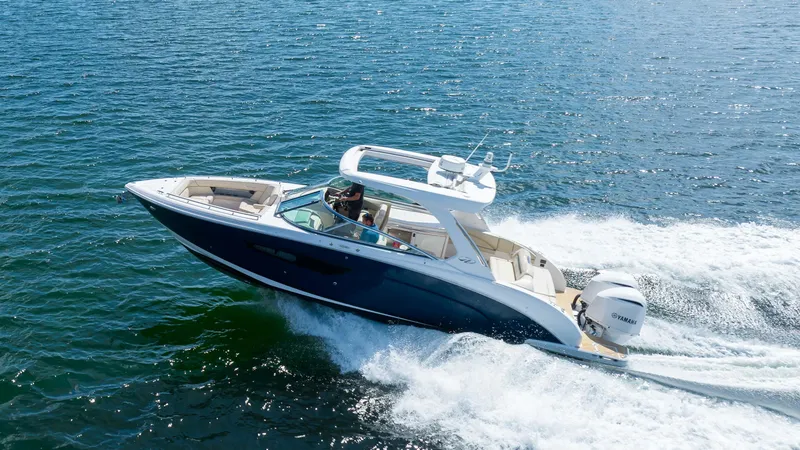 Slide: The Image of 2019 Regal 33 OBX boat cruising on open water. - 1