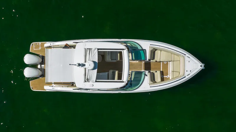 Slide: The Image of 2019 Regal 33 OBX boat, aerial view, on green water. - 14