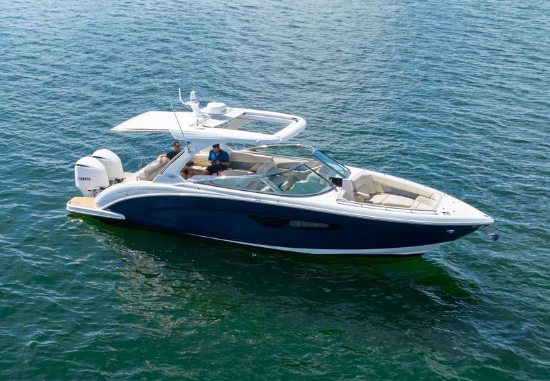Slide: The Image of 2019 Regal 33 OBX boat cruising on open water, featuring sleek design and spacious seating. - 16