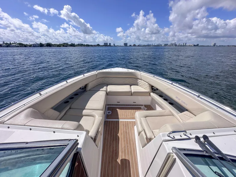 Slide: The Image of 2019 Regal 33 OBX boat with spacious seating, cruising on a sunny day. - 20