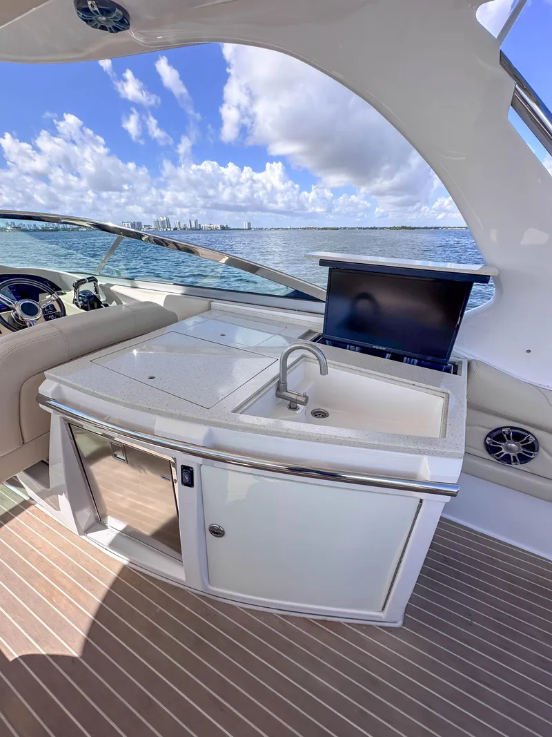 Slide: The Image of 2019 Regal 33 OBX yacht interior with kitchenette and ocean view. - 26