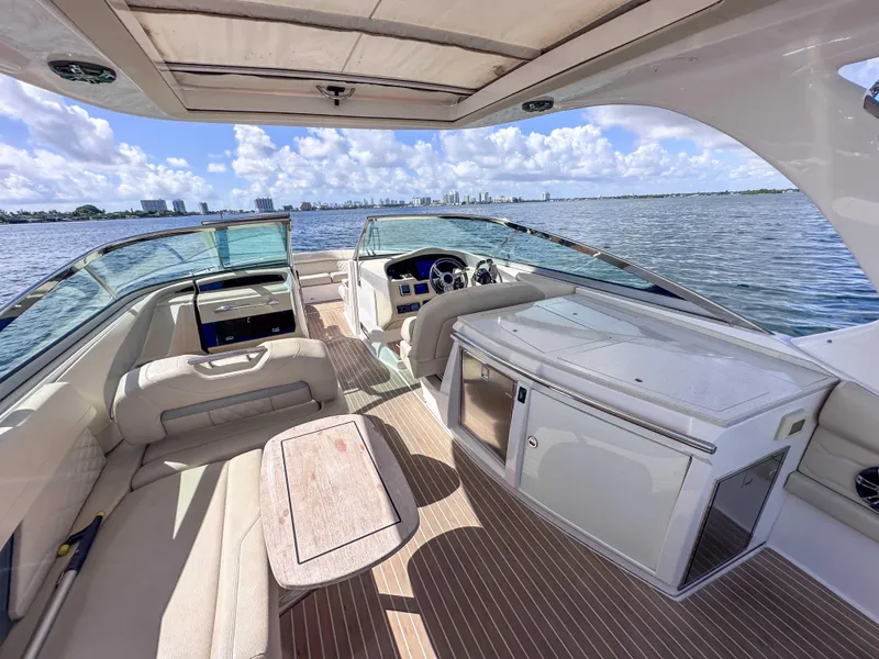 Slide: The Image of 2019 Regal 33 OBX boat interior with seating, table, and water view. - 28