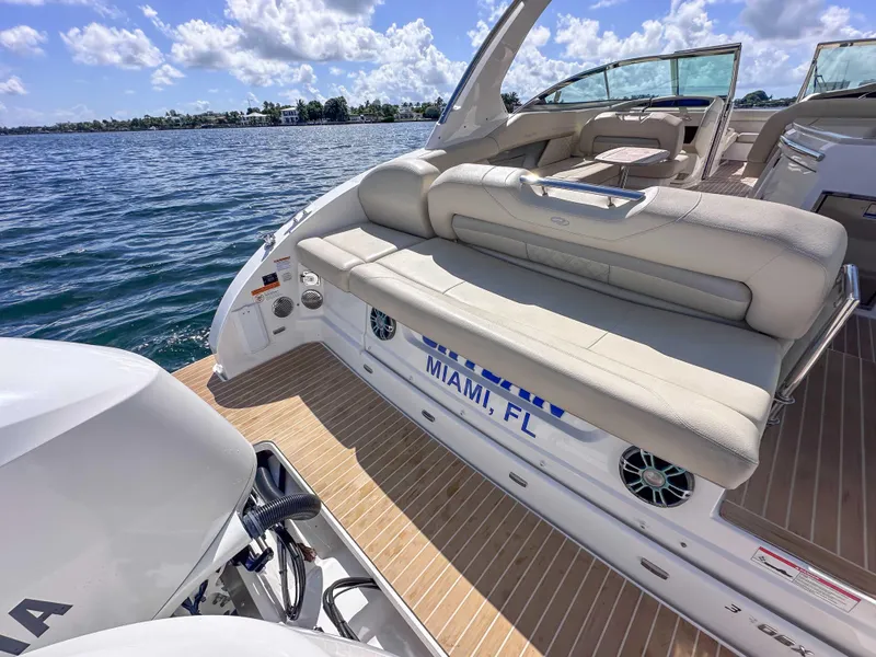 Slide: The Image of 2019 Regal 33 OBX boat with beige seating, docked in Miami, FL, under a sunny sky. - 33