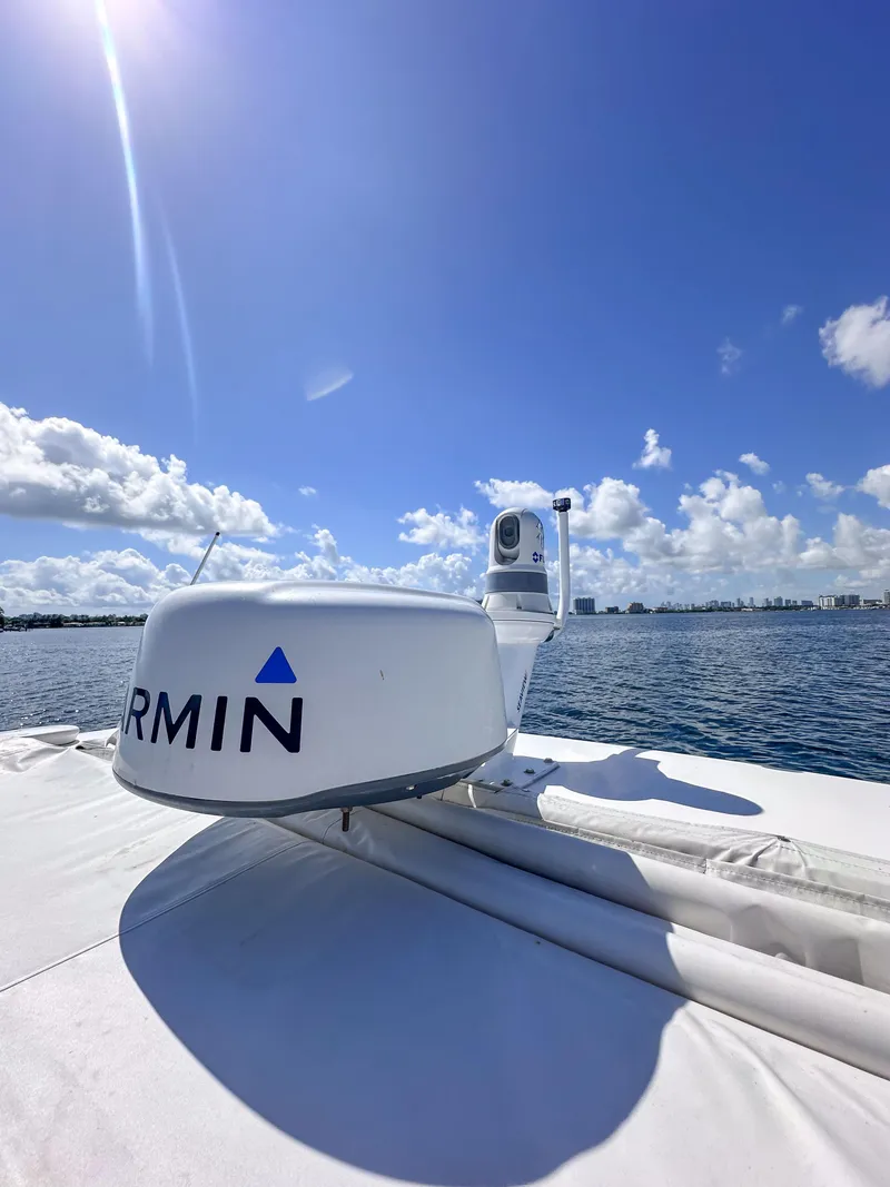 Slide: The Image of 2019 Regal 33 OBX boat with Garmin radar on a sunny day at sea. - 44
