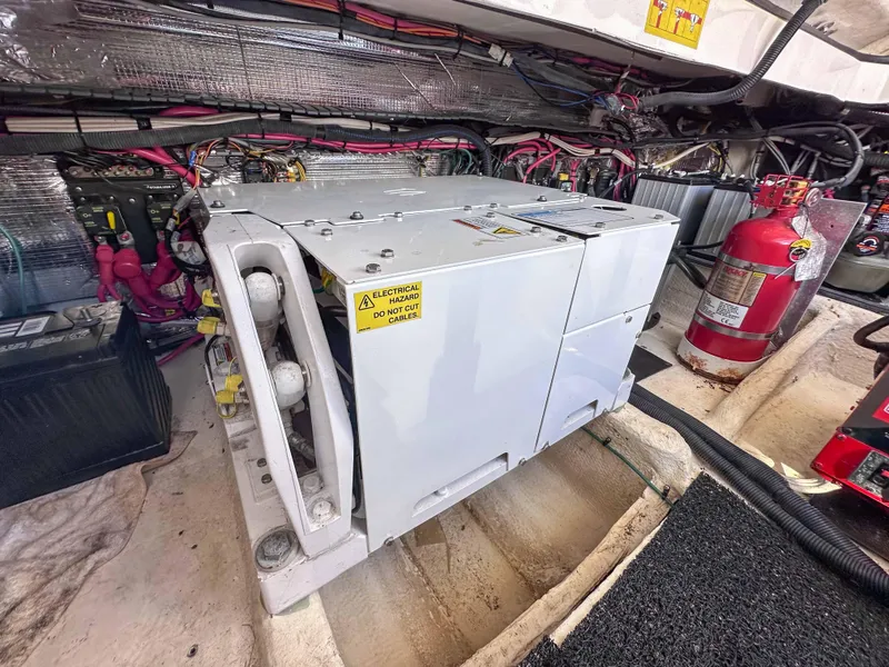 Slide: The Image of Engine compartment of 2019 Regal 33 OBX with generator and fire extinguisher. - 45