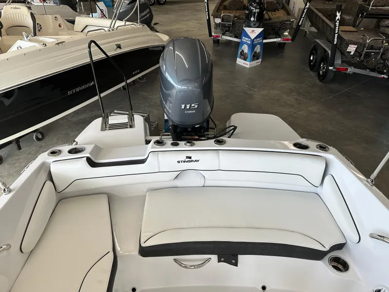 Slide: The Image of 2026 Stingray 191 DC boat interior with Yamaha 115 engine, showroom display. - 6