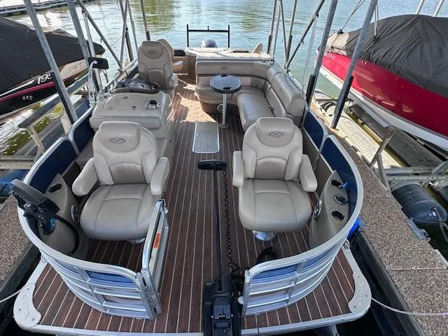 Slide: The Image of 2015 Xcursion X21F pontoon boat with spacious seating and modern design docked by the water. - 11