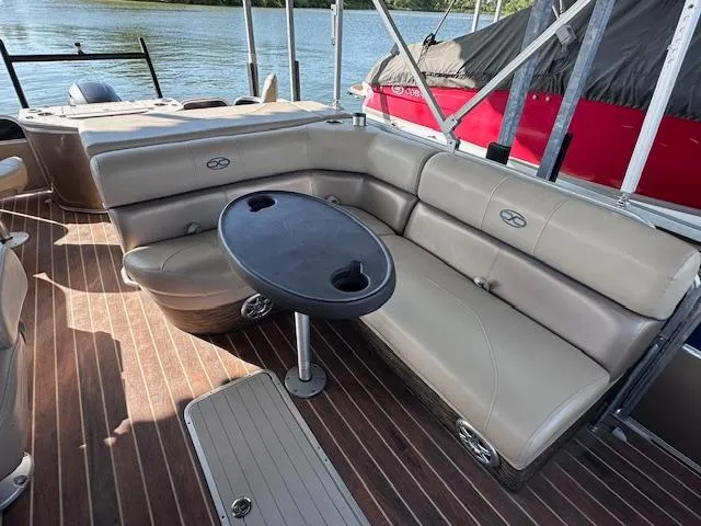 Slide: The Image of Pontoon boat interior with beige seating and round table, Xcursion X21F, 2015 model. - 12
