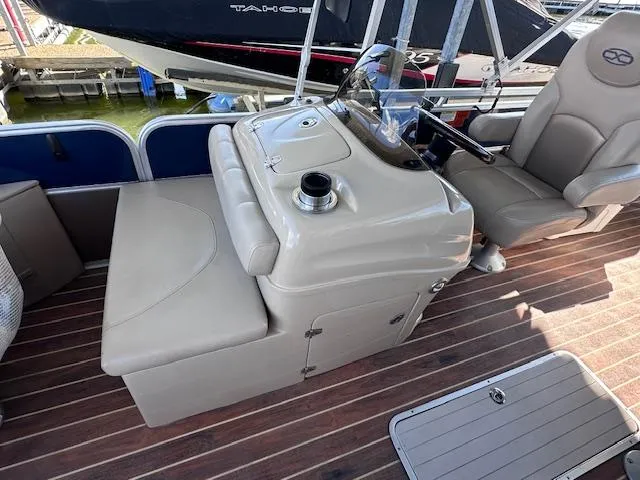 Slide: The Image of 2015 Xcursion X21F boat interior with helm and seating on wooden deck. - 15
