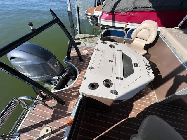 Slide: The Image of 2015 Xcursion X21F boat with outboard motor and fishing station on deck. - 19