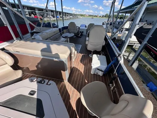 Slide: The Image of 2015 Xcursion X21F pontoon boat interior with seating, table, and lake view. - 20