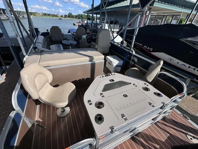 Slide: The Image of 2015 Xcursion X21F pontoon boat with seating and fishing station, docked by the lake. - 21