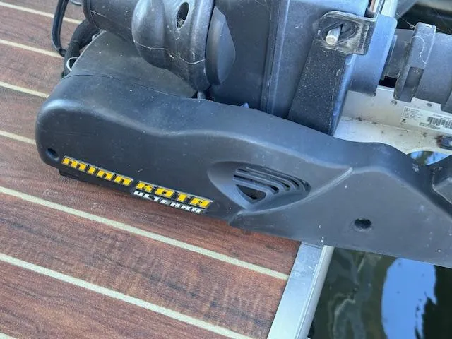 Slide: The Image of Minn Kota trolling motor on Xcursion X21F 2015 boat, docked on wooden platform. - 23