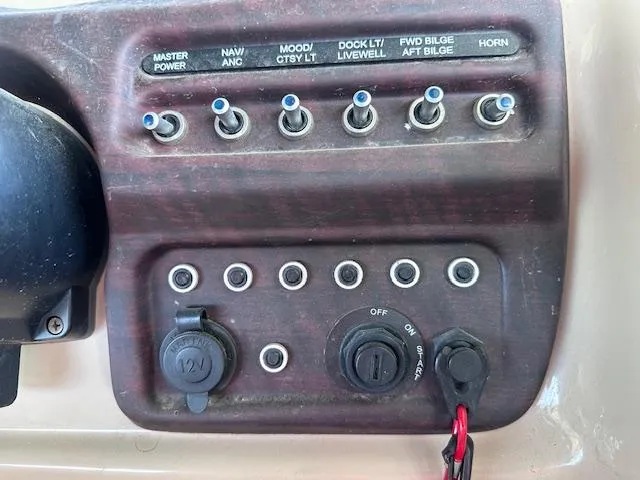 Slide: The Image of Control panel of a 2015 Xcursion X21F boat with labeled switches and outlets. - 27