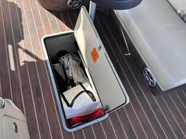 Slide: The Image of Storage compartment on 2015 Xcursion X21F boat with ropes and equipment. - 29