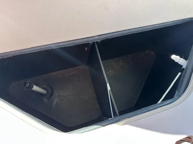 Slide: The Image of Open compartment of 2015 Xcursion X21F boat, showing interior details and fittings. - 30