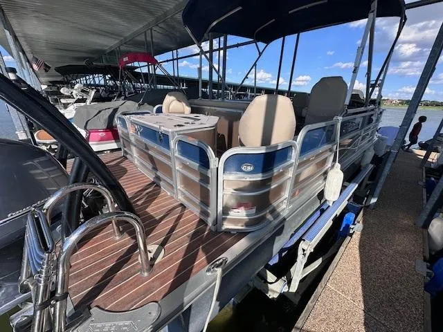 Slide: The Image of 2015 Xcursion X21F pontoon boat docked under a covered marina. - 5