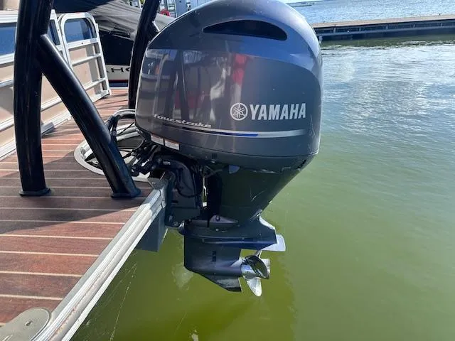 Slide: The Image of 2015 Xcursion X21F with Yamaha outboard motor on a lake. - 7