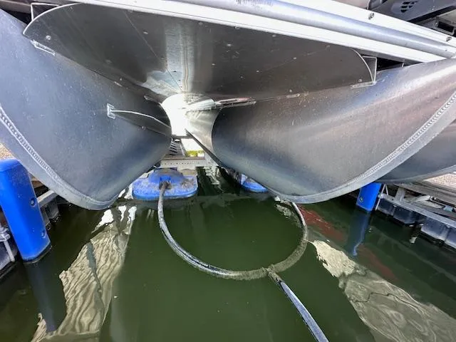 Slide: The Image of Underneath view of a 2015 Xcursion X21F pontoon boat docked on water. - 9