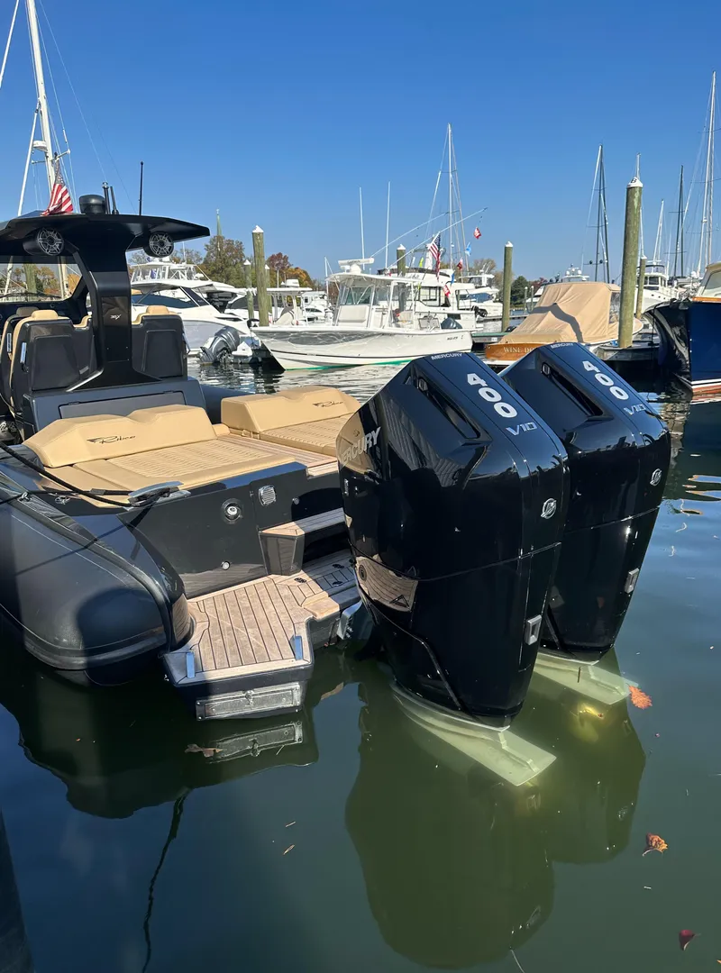 Slide: The Image of 2023 Ribco Seafarer 36 X with dual Mercury 400 engines docked at marina. - 15