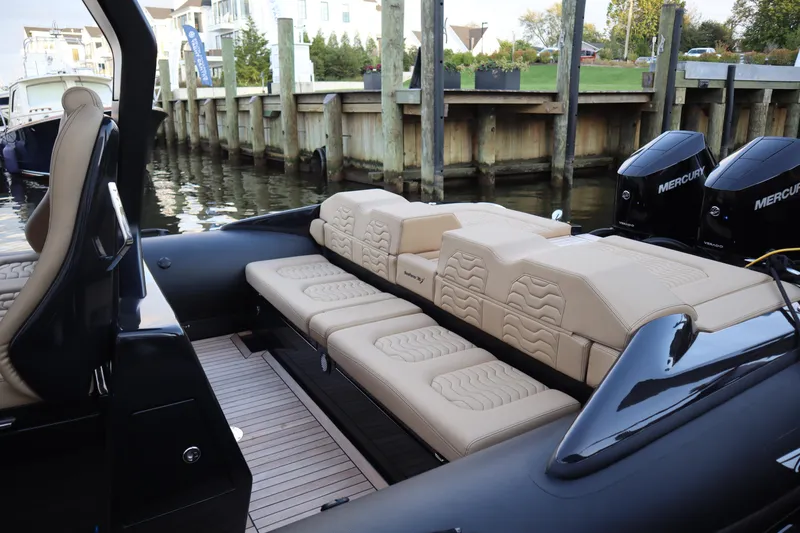 Slide: The Image of 2023 Ribco Seafarer 36 X luxury boat interior with beige seating and Mercury engines. - 22